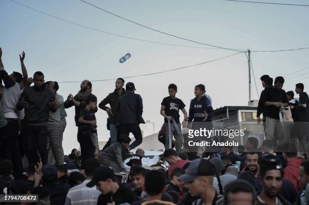 Palestinians flock around a truck carrying bottles of drinking water sent by the United Nations Children's Fund as the civilians experience water and...