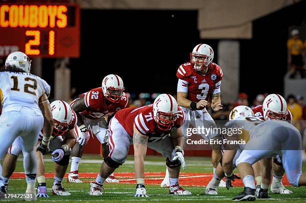 Quarterback Taylor Martinez of the Nebraska Cornhuskers awaits the snap during their game against the Wyoming Cowboys at Memorial Stadium on August...