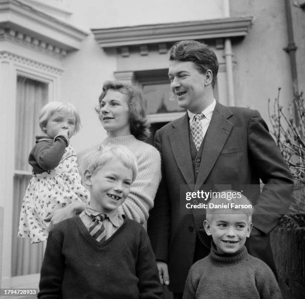 Author Kingsley Amis with his wife Hilary and children, from left, Sally, Philip and Martin Amis outside their home at 24 The Grove, Uplands,...