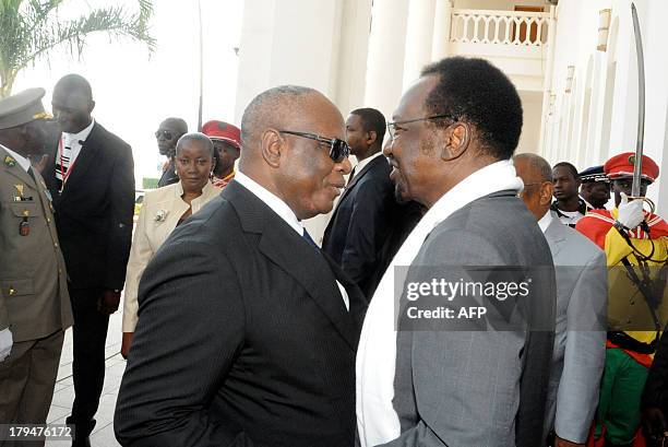 Malian new President Ibrahim Boubacar Keita listens to Mali's former interim President Dioncounda Traore on September 4, 2013 in Bamako during the...