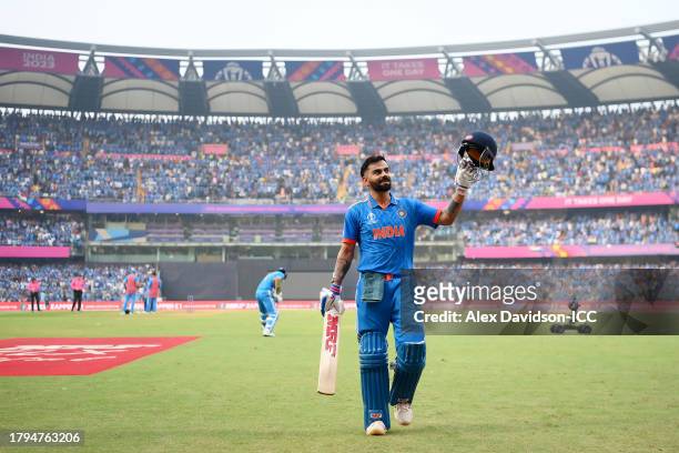 Virat Kohli of India acknowledges the fans while leaving the field after being dismissed by Tim Southee of New Zealand after scoring a century during...