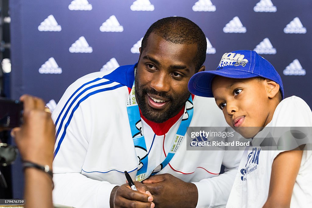 Members Of The French Judo Team Visit The Adidas Champs-Elysees Store