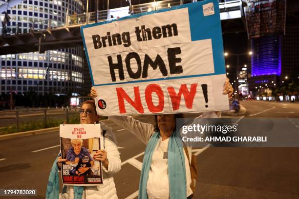 Families of Israeli hostages held by Palestinian militants in the Gaza Strip protest outside the ministry of defence in Tel Aviv calling on November...