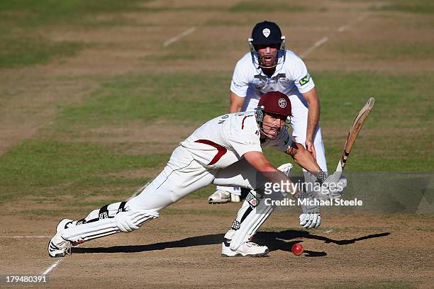 Nick Compton of Somerset plays to the offside as Richard Johnson of Derbyshire looks on during day two of the LV County Championship Division One...