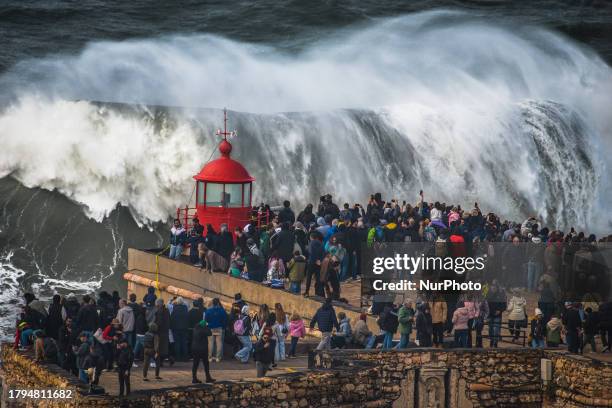 Hundreds of spectators are gathering at the Nazare lighthouse in Nazare, Portugal, on November 5 to take advantage of the forecasted giant waves....