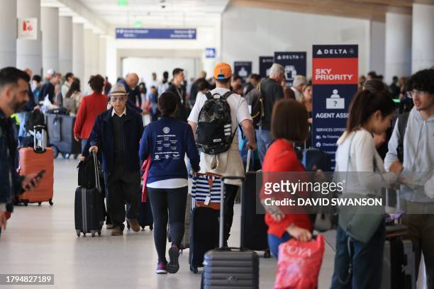 Crowds pass through a terminal at Los Angeles International Airport on November 21 in Los Angeles, as people travel ahead of the Thanksgiving holiday.