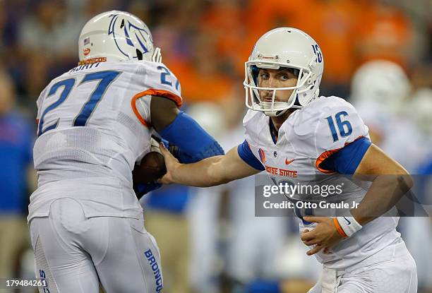 Quarterback Joe Southwick of the Boise State Broncos hands off to Jay Ajayi against the Washington Huskies on August 31, 2013 at Husky Stadium in...