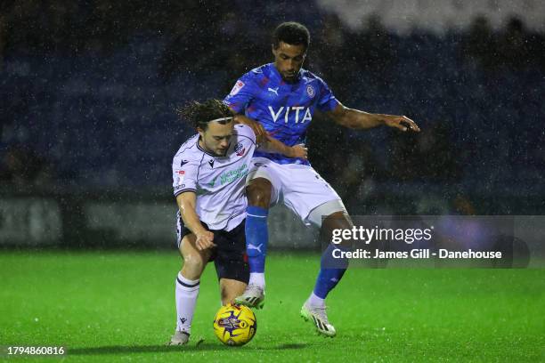 Ibou Touray of Stockport County battles for possession with Luke Matheson of Bolton Wanderers during the EFL Trophy match between Stockport County v...