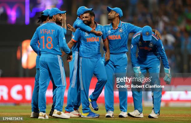Mohammed Shami of India celebrates with teammates after dismissing Rachin Ravindra of New Zealand during the ICC Men's Cricket World Cup India 2023...