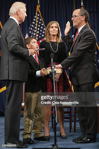 Vice President Joe Biden conducts a ceremonial swearing-in for Labor Secretary Thomas Perez with his wife Ann Marie Staudenmaier and son Rafael Perez...