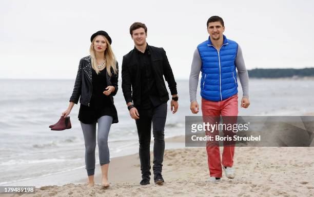 Daniel Grunenberg and Carolin Niemczyk of the pop band Glasperlenspiel walk on the beach of Usedom with WBO Cruiserweight champion Marco Huck of...
