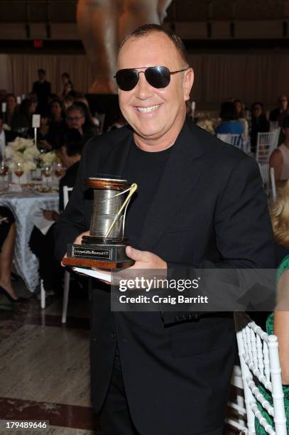 Designer Michael Kors poses with his award at The Couture Council of The Museum at the Fashion Institute of Technology hosted luncheon honoring...