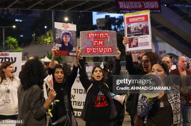 Families of Israeli hostages held by Palestinian militants in the Gaza Strip protest outside the ministry of defence in Tel Aviv calling on November...