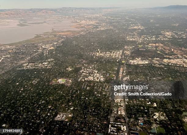 Aerial view of residential and commercial areas with lush greenery on a clear day, Redwood City, Silicon Valley, California, July 21, 2023.