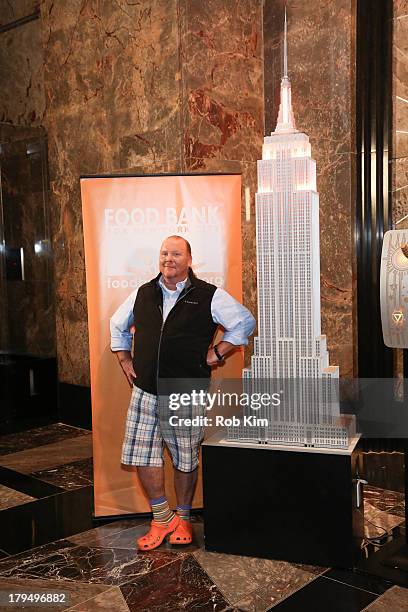 Mario Batali lights the Empire State Building orange to raise hunger awareness at The Empire State Building on September 4, 2013 in New York City.