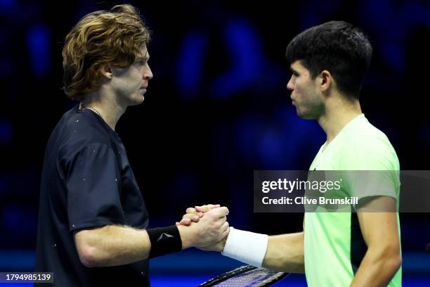 Andrey Rublev shakes hands with Carlos Alcaraz of Spain after their Men's Singles Round Robin match on day four of the Nitto ATP Finals at Pala...