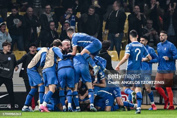 Greece's players celebrate after scoring their first goal during the UEFA Euro 2024 Group B second leg qualifying football match between Greece and...