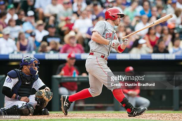 Jack Hannahan of the Cincinnati Reds singles in the sixth inning of a game against the Colorado Rockies at Coors Field on September 1, 2013 in...