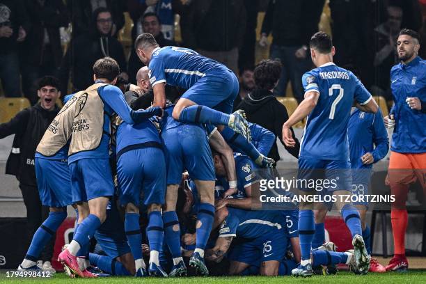 Greece's players celebrate after scoring their first goal during the UEFA Euro 2024 Group B second leg qualifying football match between Greece and...