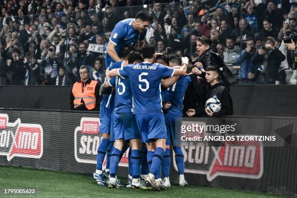 Greece's players celebrate after their forward Fotis Ioannidis scored their second goal during the UEFA Euro 2024 Group B second leg qualifying...