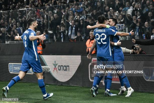 Greece's players celebrate after their forward Fotis Ioannidis scored their second goal during the UEFA Euro 2024 Group B second leg qualifying...