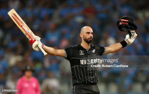 Daryl Mitchell of New Zealand celebrates after scoring a century during the ICC Men's Cricket World Cup India 2023 Semi Final match between India and...