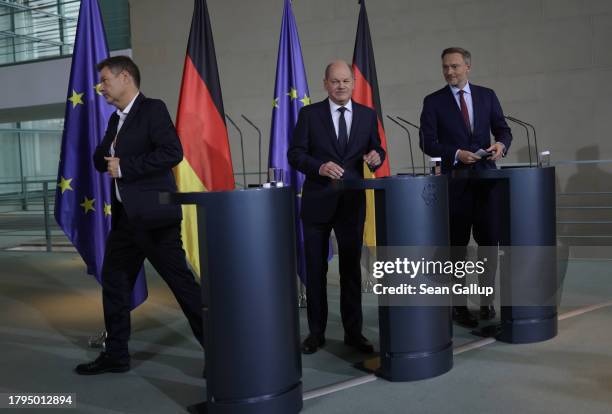 German Chancellor Olaf Scholz , Finance Minister Christian Lindner and Economy Minister Robert Habeck depart after they gave statements to the media...