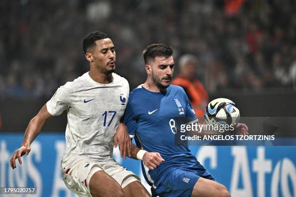 France's defender William Saliba fights for the ball with Greece's forward Fotis Ioannidis during the UEFA Euro 2024 Group B second leg qualifying...