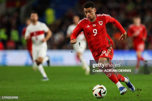 Wales' midfielder Brennan Johnson controls the ball during the UEFA Euro 2024 Group D qualifying football match between Wales and Turkey, at Cardiff...