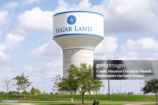 Water tower or elevated storage tank , uses gravity and the weight of the water contained in the tank to control the pressure and flow of water...