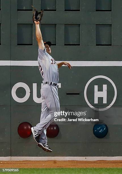 Andy Dirks of the Detroit Tigers catches a fly ball at the wall against the Boston Red Sox during the game on September 4, 2013 at Fenway Park in...