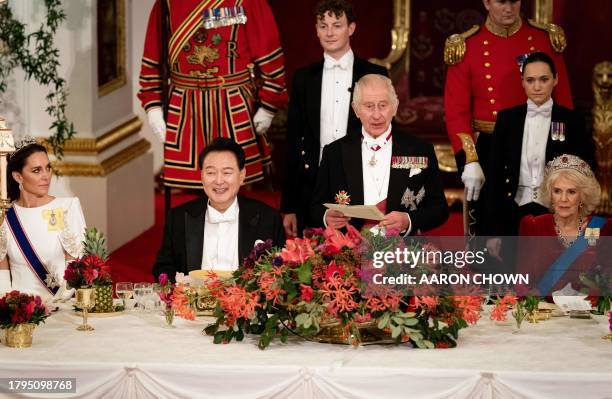 Britain's King Charles III , flanked by Britain's Catherine, Princess of Wales and Britain's Queen Camilla , speaks next to South Korea's President...