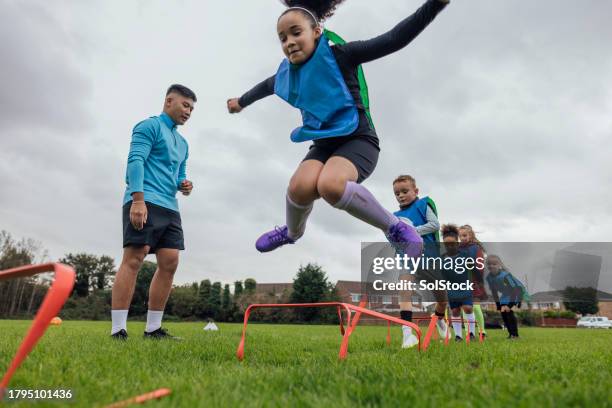 agility hurdle drills - multi ethnic group of kids stock pictures, royalty-free photos & images