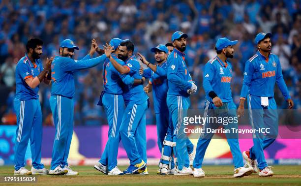 Mohammed Shami of India celebrates with teammates after dismissing Daryl Mitchell of New Zealand during the ICC Men's Cricket World Cup India 2023...