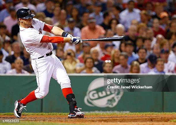 Will Middlebrooks of the Boston Red Sox hits a grand slam home run in the 6th inning off of Al Alburquerque of the Detroit Tigers during the game on...