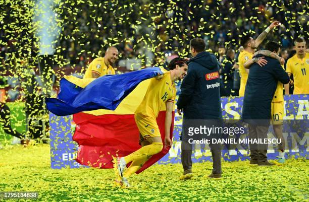 Romania's midfielder Ianis Hagi celebrates with Romania's flag at the end of the UEFA Euro 2024 Group I qualification football match between Romania...
