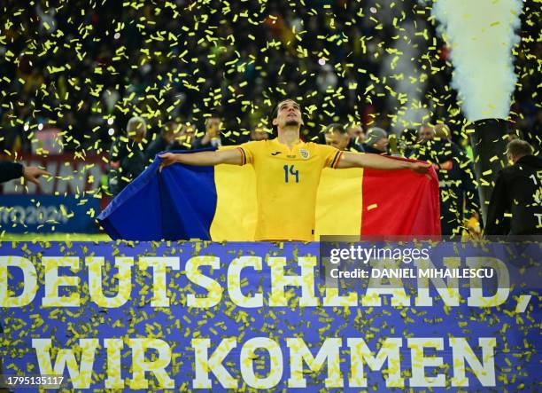 Romania's midfielder Ianis Hagi celebrates with Romania's flag at the end of the UEFA Euro 2024 Group I qualification football match between Romania...