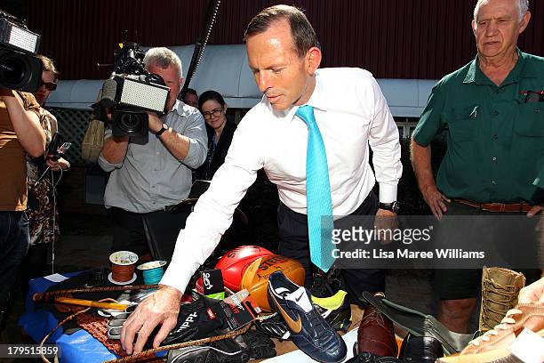 Australian Opposition Leader, Tony Abbott inspects some shoes at Packer Leather on September 5, 2013 in Brisbane, Australia. The Liberal-National...