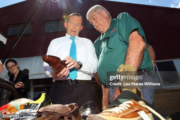 Australian Opposition Leader, Tony Abbott inspects some shoes at Packer Leather on September 5, 2013 in Brisbane, Australia. The Liberal-National...