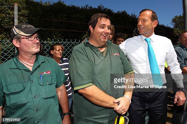 Australian Opposition Leader, Tony Abbott poses with staff at Packer Leather on September 5, 2013 in Brisbane, Australia. The Liberal-National Party...