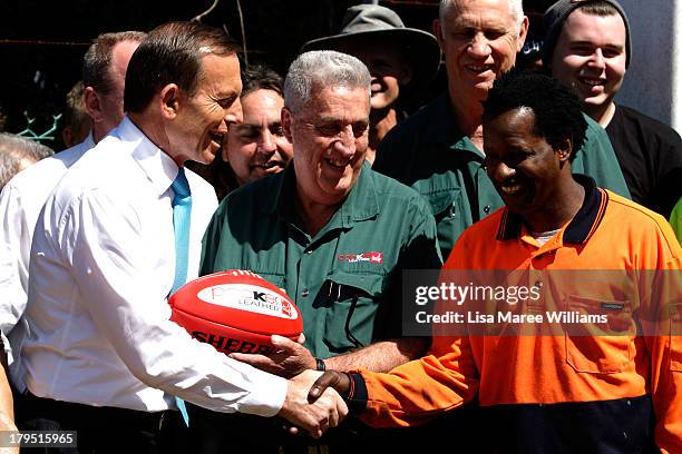 Australian Opposition Leader, Tony Abbott poses with staff at Packer Leather on September 5, 2013 in Brisbane, Australia. The Liberal-National Party...