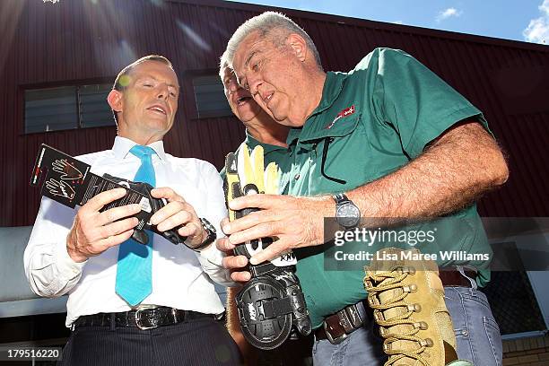 Australian Opposition Leader, Tony Abbott inspects some leather goods at Packer Leather on September 5, 2013 in Brisbane, Australia. The...