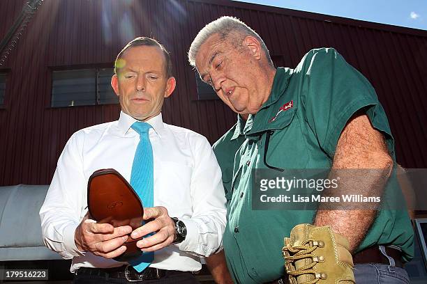 Australian Opposition Leader, Tony Abbott inspects some leather goods at Packer Leather on September 5, 2013 in Brisbane, Australia. The...