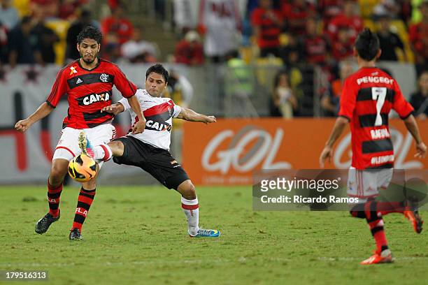 Wallace of Flamengo fights for the ball with Maxi Biancucchi of Vitoria during the match between Flamengo and Vitoria for the Brazilian Series A 2013...