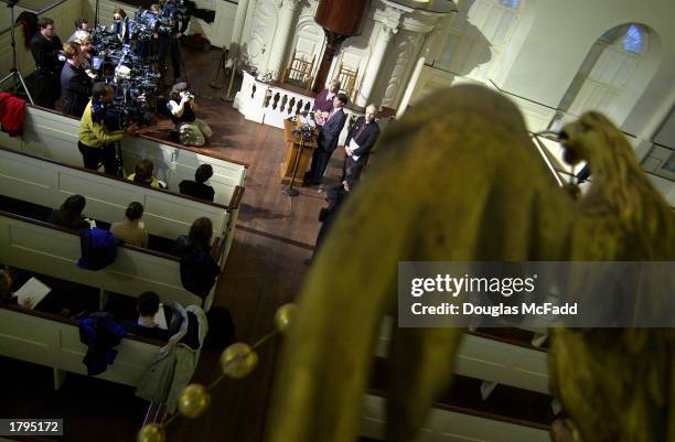 The figure of an eagle appears over a press conference with attorney John Bonifaz in the Old South Meeting House February 13, 2003 in Boston. A...
