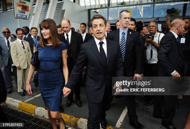 French President Nicolas Sarkozy and his wife Carla Bruni-Sarkoy arrives at Lamentin airport on January 7, 2011 in Fort-de-France, on the French...