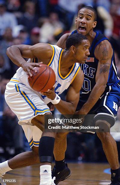 Dijon Thompson of the UCLA Bruins tries to drive to the basket against Dahntay Jones of Duke University Blue Devils during the John R. Wooden...