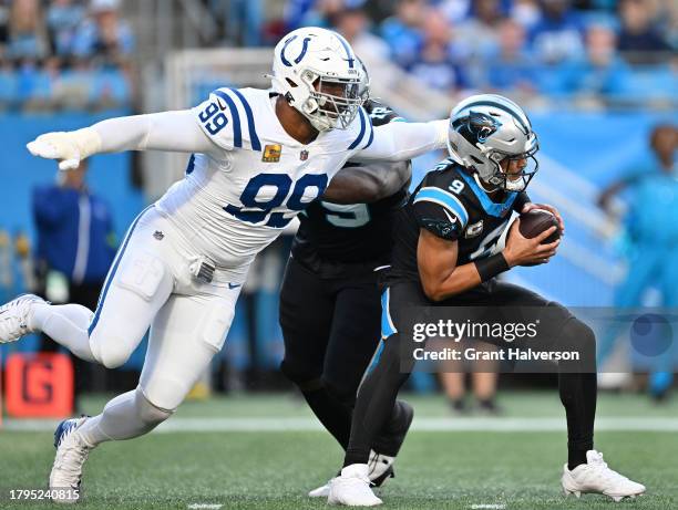 DeForest Buckner of the Indianapolis Colts pressures Bryce Young of the Carolina Panthers during the game at Bank of America Stadium on November 05,...