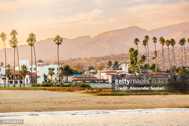 santa barbara beach with palm trees and city skyline at sunset, california, usa - santa barbara stock pictures, royalty-free photos & images