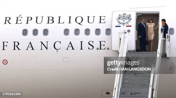 French president Nicolas Sarkozy and his wife Carla Bruni-Sarkozy disembark from the new French presidential Airbus A330 airplane as they arrive in...